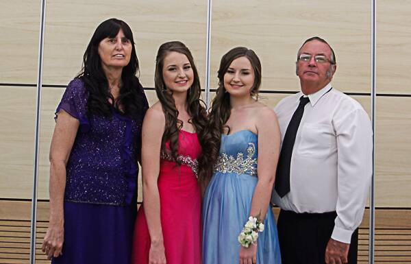 TAPP FAMILY: It has been 29 years from when Jean  and Wayne Tapp's first Child Damian graduated his schooling until the last of their children graduated this year. Twins Mikaela (second from left) and Monique  (second from right) stand by their proud parents Jean and Wayne Tapp at their graduation.