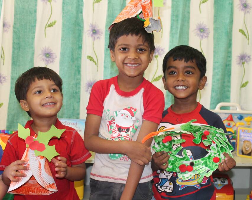 DECK THE HALLS: Ihsan Mohammed, 2, Isam Mohammed, 5, and Methuka Wickramasinghe, 3, showed off the Christmas decorations they created to decorate Cloncurry’s community Christmas tree. – Picture: HAILEY RENAULT/7862