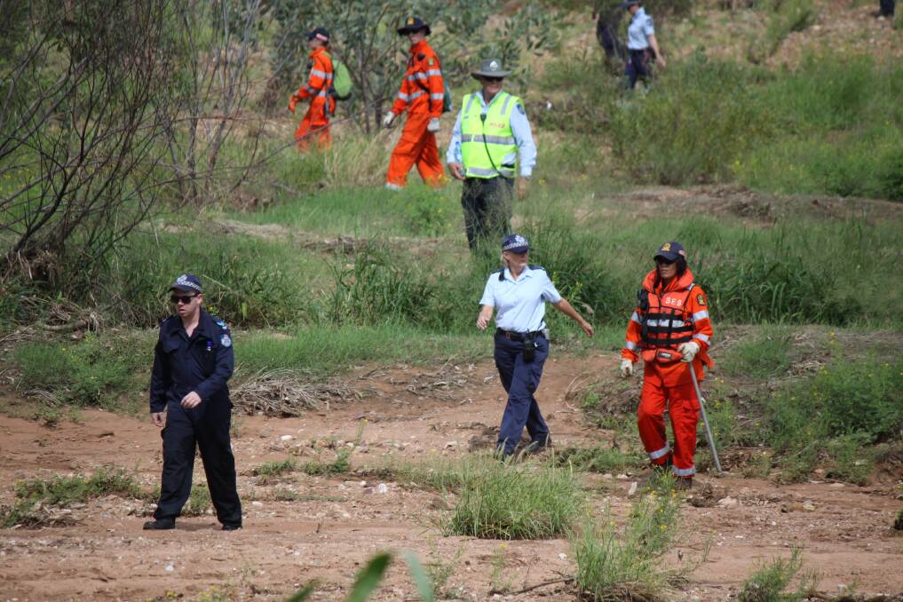 Police, SES and mine rescue crews scour the riverbed.