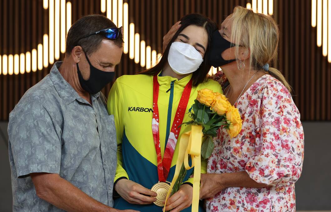 Gold medallist Jakara Anthony (centre), her father Darren (left) and mother Sue (right) embrace after she returned to Melbourne Airport on Wednesday, February 9. Photo: Robert Cianflone via Getty Images.