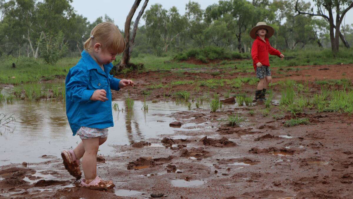 Follow-up rain is vital after 10 years of drought in most of Queensland, but for now the Campbell kids at Rosebud Station, Cloncurry are happy. Picture: Samantha Campbell