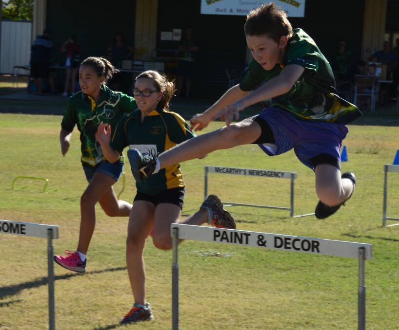 RUN, RUN, JUMP: Athletes Sienna Te Wani, 12, Kadea O'Donnell, 11, and Corey Stewart, 11, practice hurdles. Photo: Chris Burns. 