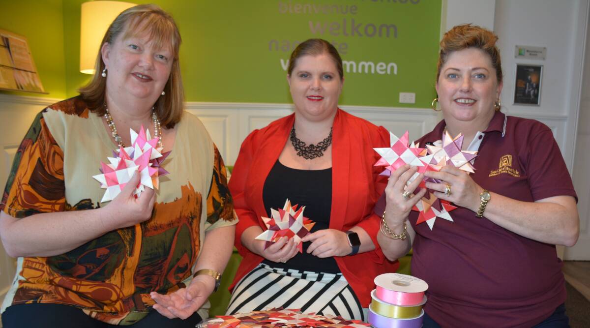  Mount Isa Zonta Club represerntatives Liza Dowler, Laura Ousby and Cathy Warren with ribbon stars they have made. Photo: Chris Burns. 