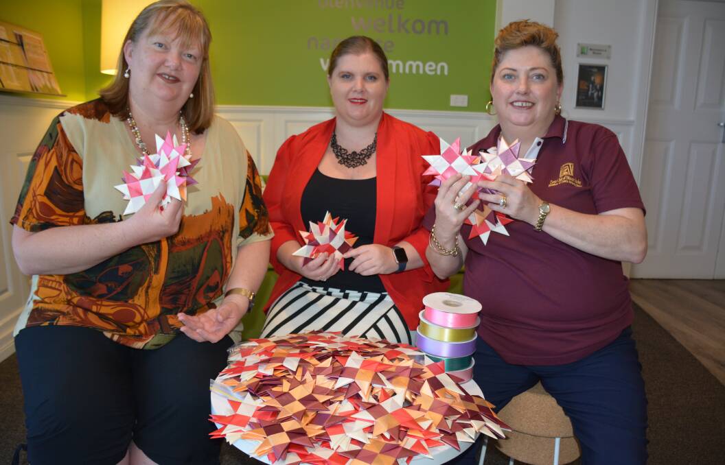 STAR POWER: Mount Isa Zonta Club members Liza Dowler, Laura Ousby and Cathy Warren gather the woven stars they have made for the One Million Star Project. Photo: Chris Burns. 