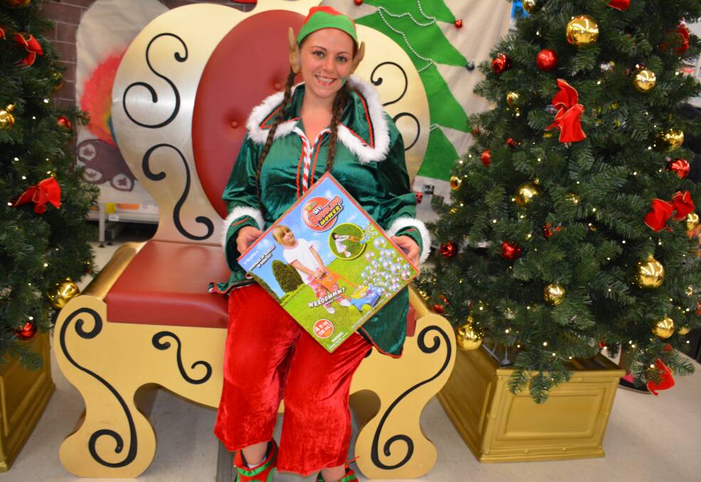 CHRISTMAS CHEERER: Kmart's elf-in-residence Mel Bohan waits for Santa to visit the store after the Christmas tree launch on Saturday. Photo: Chris Burns. 