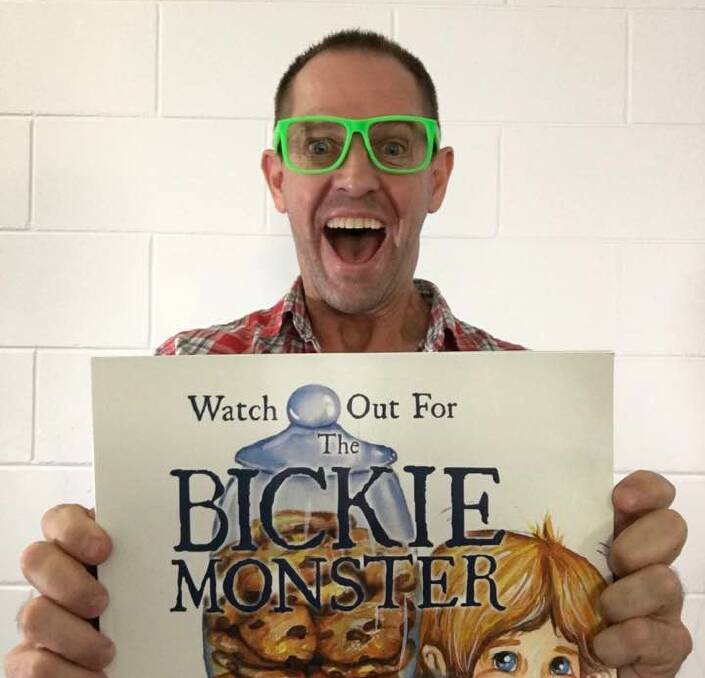 MENTOR: Children's book author Ian McIntosh with his book 'Watch Out For The Bickie Monster." Photo: Supplied. 