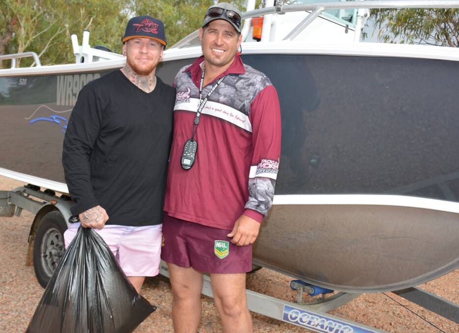 ON A MISSION: Cory Barram and Nathan Richardson have the boat ready to search Lake Moondarra for rubbish. Photo: Chris Burns. 