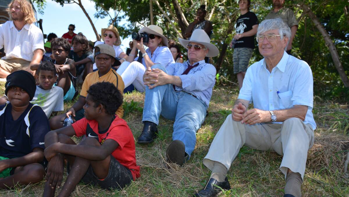 IN THE SHADE: The Mornington Shire community, Bob Katter and Dick Smith sit together under the shade to listen to Macca perform during the community garden project opening.  Photo: Chris Burns. 