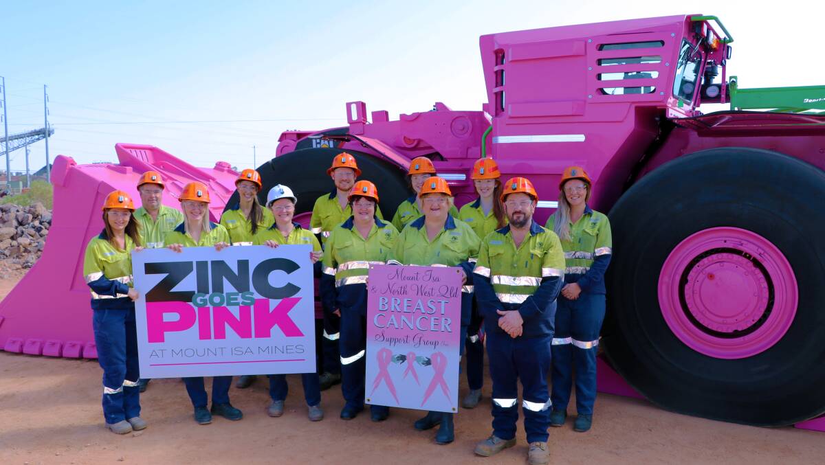 North West Breast Cancer Support Group members with Glencore representatives in front of the pink 50 tonne Caterpillar R2900G Loader which will have its name auctioned. Photo: Mount Isa Mines. 