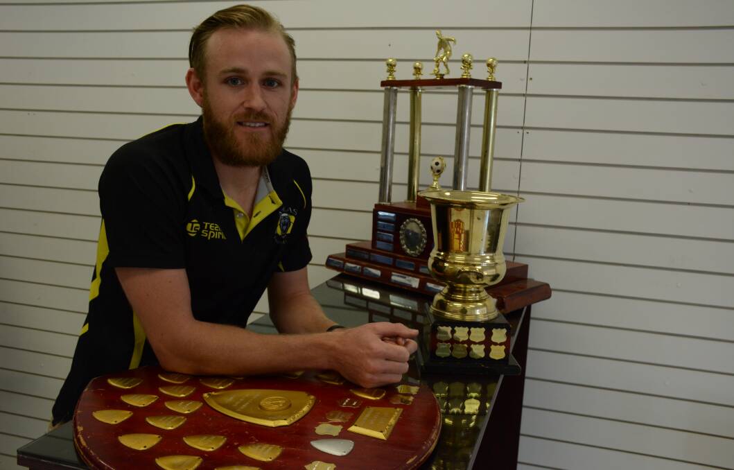 THREE TROPHIES: Atlas player Andrew Frahm with the three trophies; the minor premiership, the Scottish Cup, and the yet to be contested  trophy for the major premiership. 