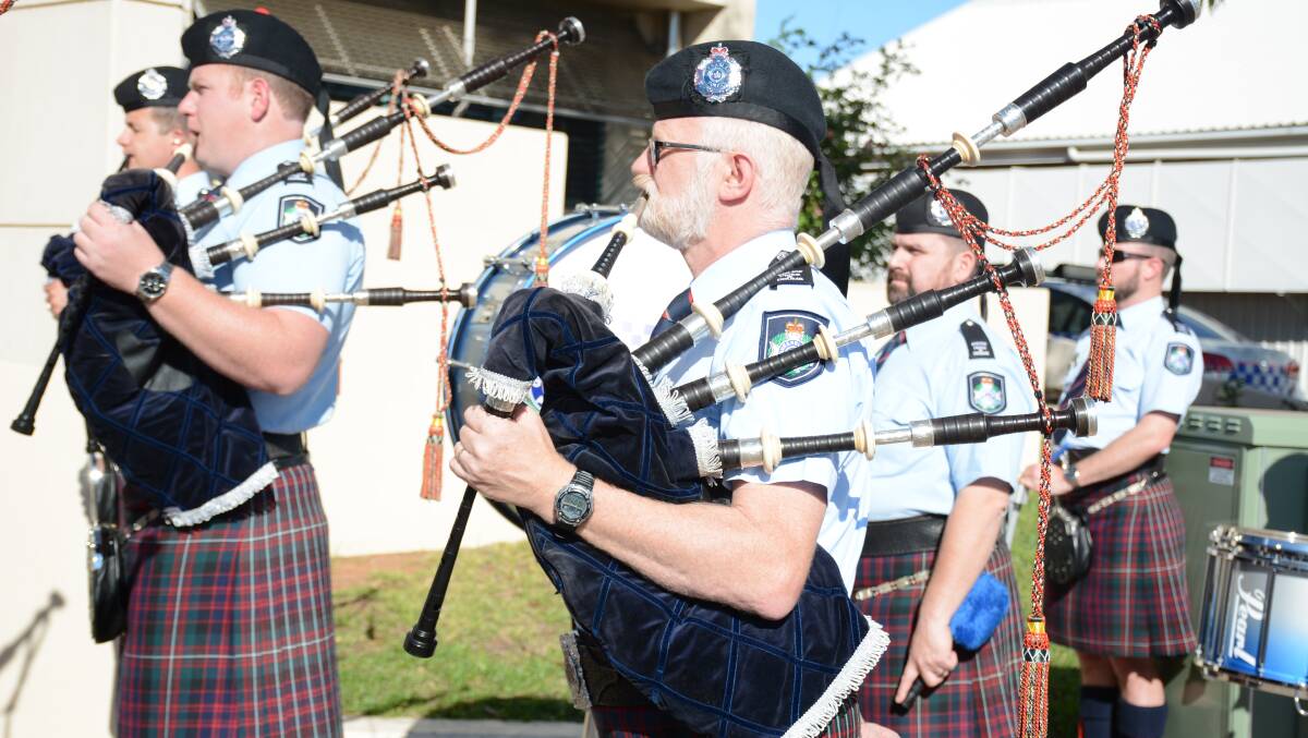 BAGPIPE TUNES: The Queensland Police Pipes and Drums band perform at the NAIDOC flag raising ceremony in front of Mount Isa Police Headquarters. Photo: Chris Burns. 