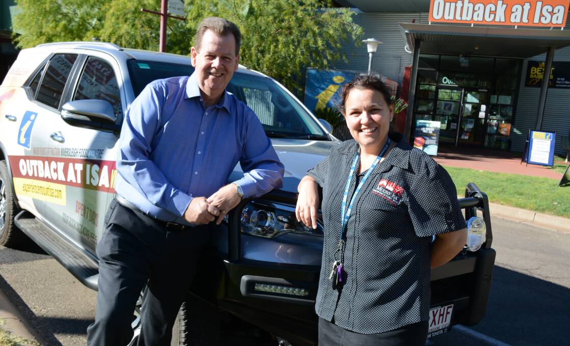 MOBILE OFFICE: Bell & Moir Toyota dealer principal Lee Pulman and Outback at Isa's tourism manager Kylie Rixon with the new Toyota on loan. Photo: Chris Burns. 