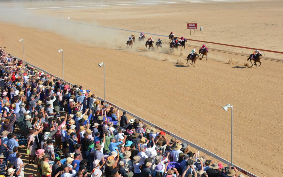 PACKED: The crowd watches the Birdsville Races as close as they can to the action during the two day race event in 2015. Photo: Chris Burns. 