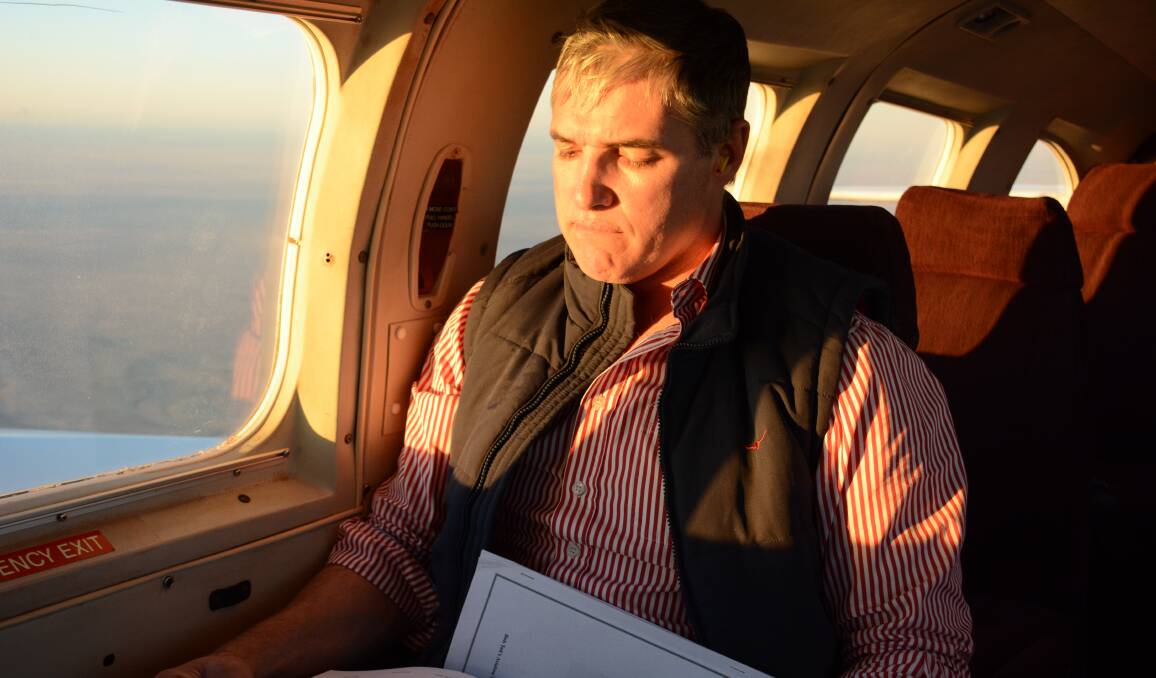 State MP Rob Katter catches up on his readings on the way to Mount Isa, shortly after his comments about the poll on Sunday trading. Photo: Chris Burns. 