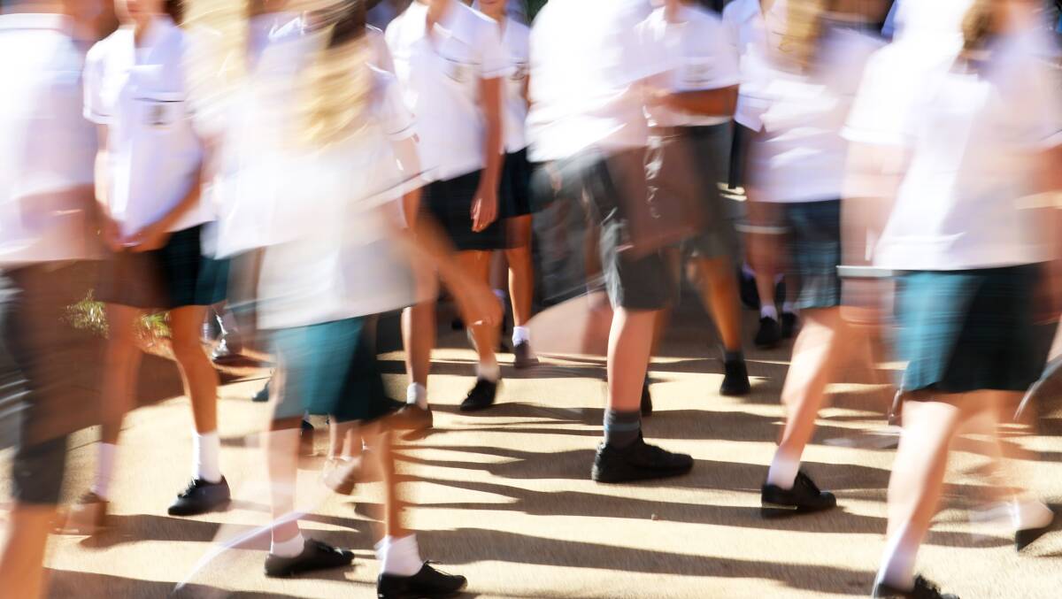 Students under stay-at-home orders in the ACT are allowed to attend school and outside of school care if they wear a mask. Picture: Shutterstock