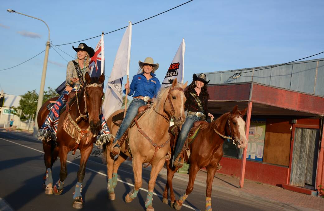FLYING THE FLAG: Cloncurry's Miss Rodeo representatives lead the way for the 2017 Curry Merry Muster street parade. 