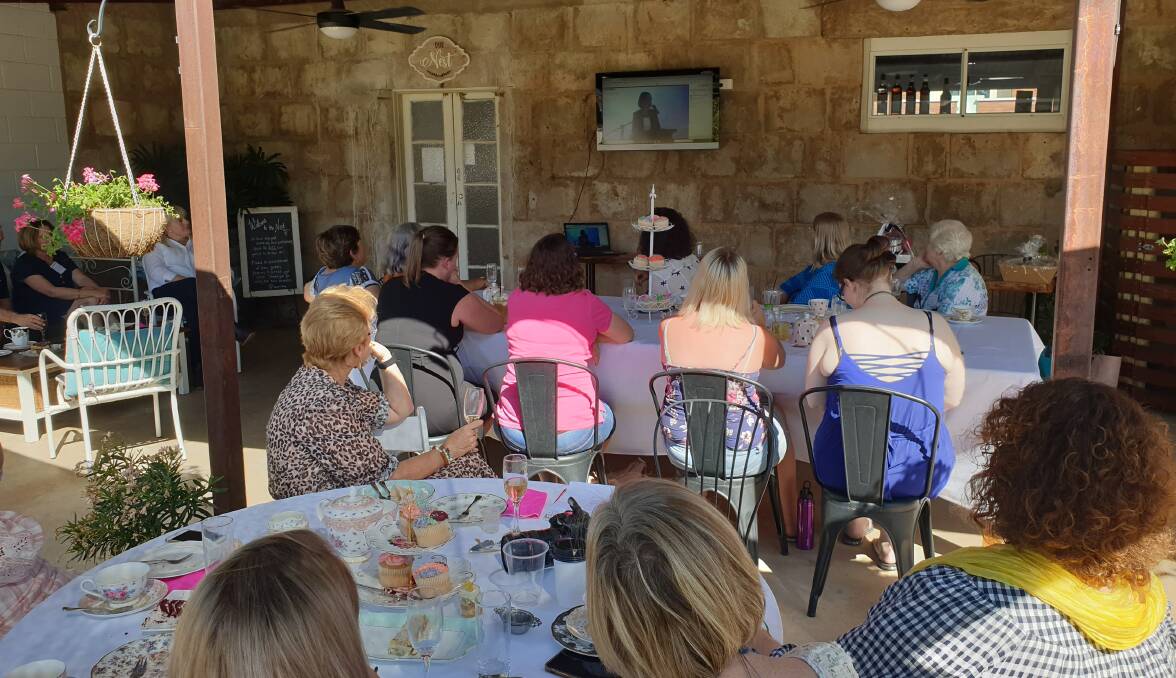 Charleville high tea attendees watching the livestream from Charlotte's Nest.