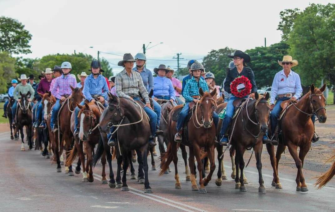 Mark of respect: Some of the 80 Campdraft 4 a Cause riders taking part in Hughenden's Anzac Day march. Pictures: Kimberley Johnson.