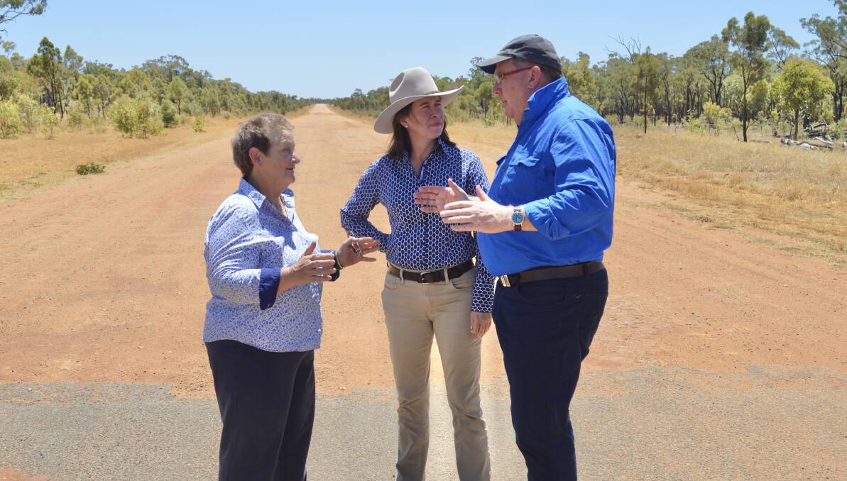 Flinders Shire mayor Jane McNamara discusses the width of the pavement for future sealing work with LNP Queensland Senator Susan McDonald and federal Assistant Minister for Road Safety and Freight Transport Scott Buchholz. Picture supplied.