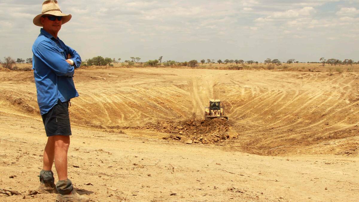 Cam Maxwell watching a dam being desilted at Hazelwood, west of Isisford, in December 2012. Picture: Sally Gall