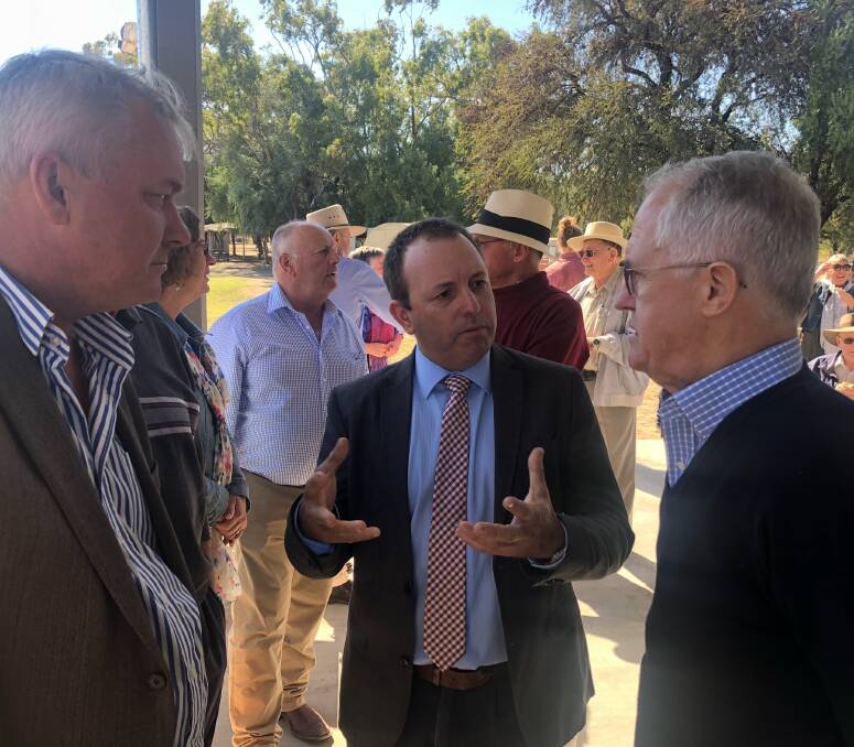 AgForce north regional president, Dominic Burden, centre, taking advantage of the opportunity to speak with Prime Minister, Malcolm Turnbull in Blackall recently, with state MP, Lachlan Millar listening in.