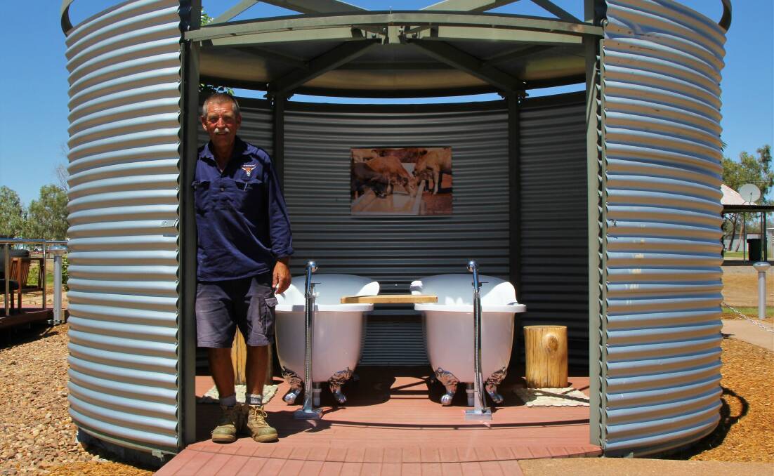 Julia Creek caravan park manager, Phil Charlier and the interior of one of the bathing 'water tanks'. Picture - Sally Cripps.