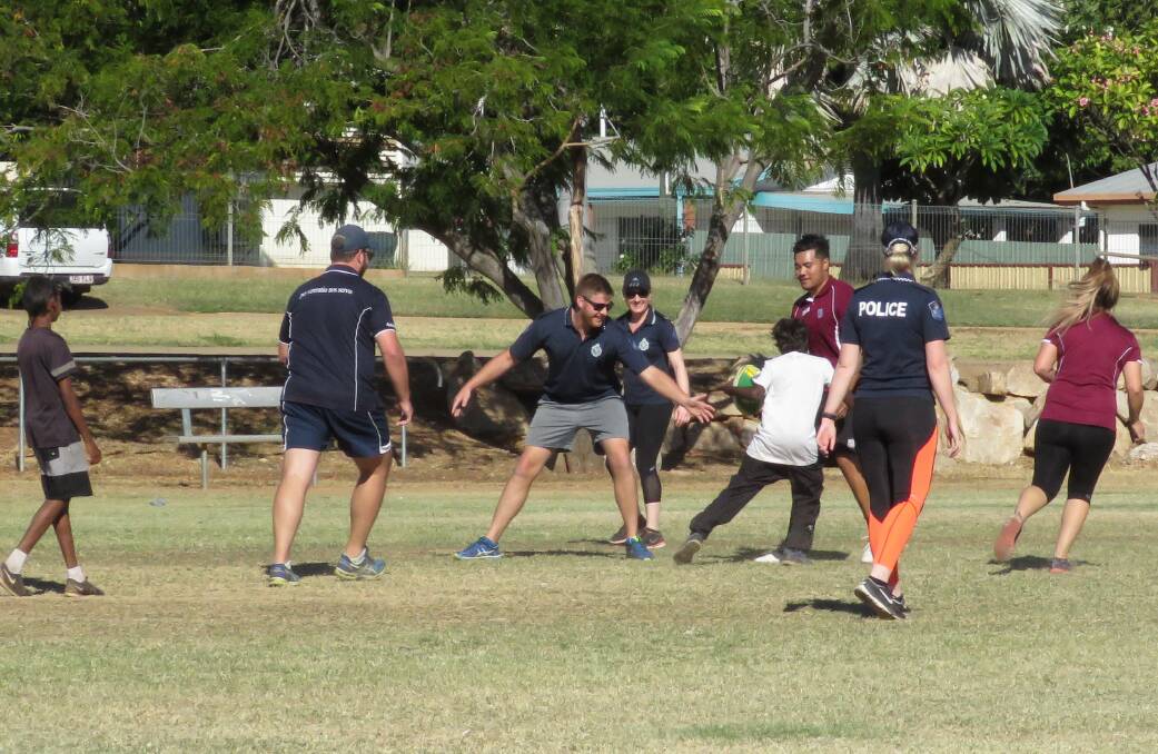 Mount Isa Police play Thursday footy with local young 'uns.