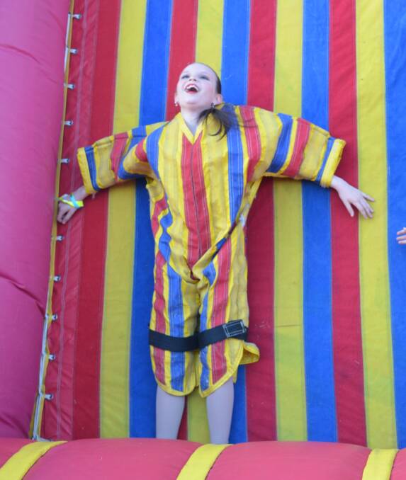 GREAT FETE: Willow Shaw enjoying the bouncy castle at last year's fete. Photo: Derek Barry