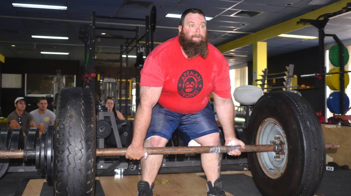 STRONG AND STATIC: Doing the dead lift with tyres and coming in second place for Mount Isa Strongman Static Monsters was Clinton Graveson. Photo: Derek Barry