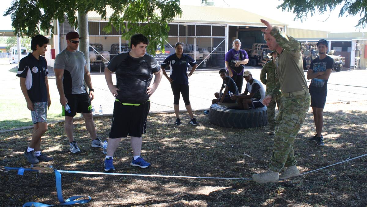 BALANCING ACT: Major Jeremy Barraclough of Delta Company, 51st Battalion, Far North Queensland Regiment, shows Project Booyah students how to work the tight rope. Photo: Esther MacIntyre