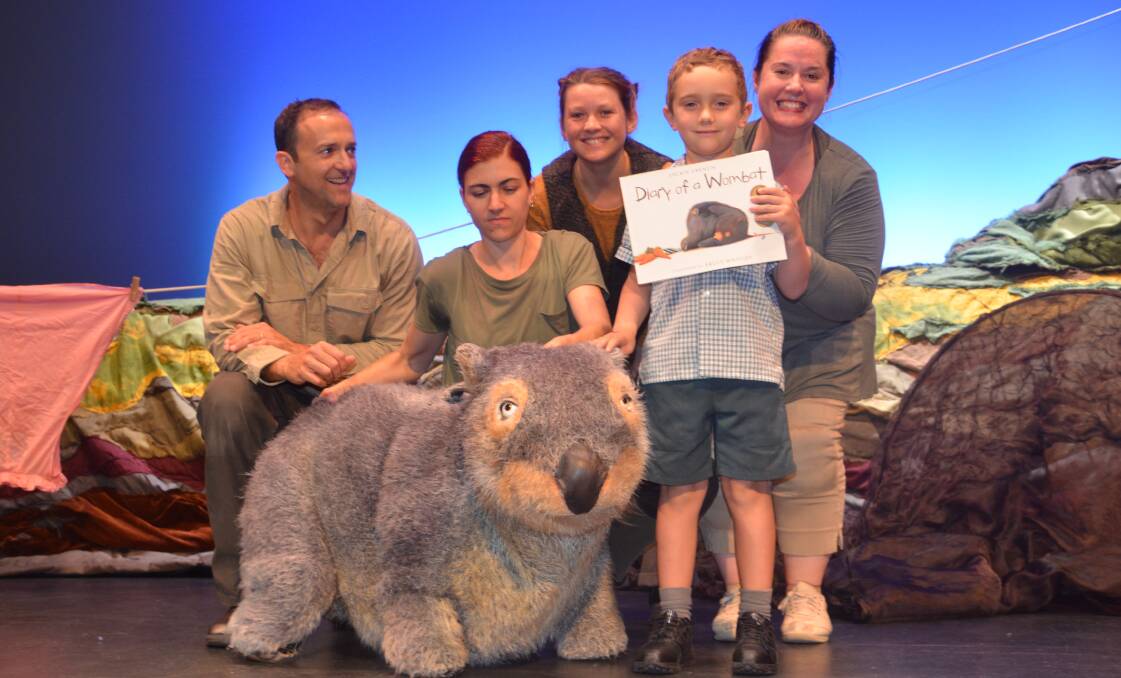 WOMBAT TALES: Diary of a Wombat puppeteers and performers, Michael Cullen, Samantha Hickey, Mary Rapp (cellist), and Shondelle Pratt with Kayde Gebhardt
from St Joseph's School, and his signed picture book. Photo: Esther MacIntyre