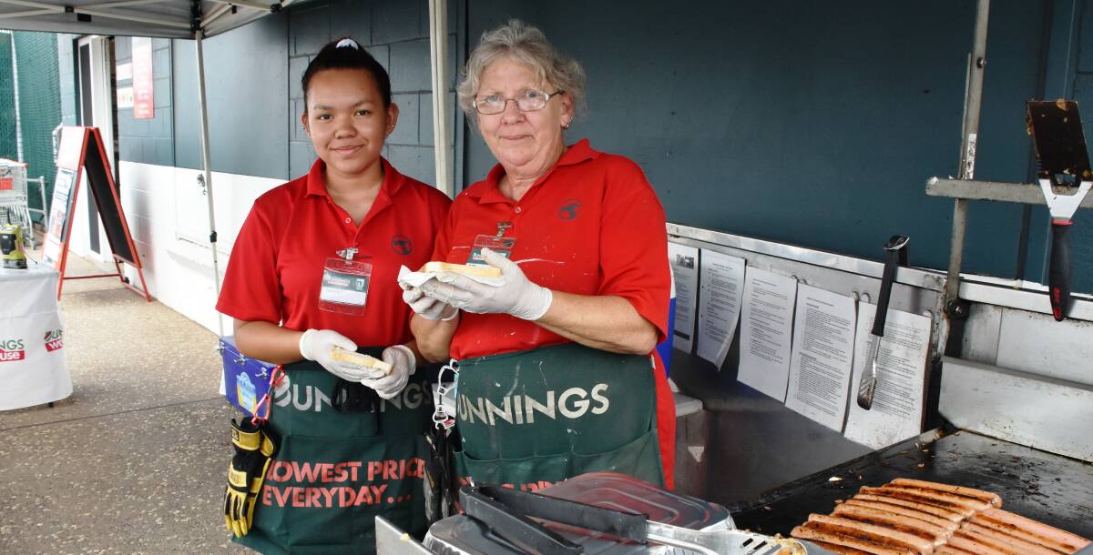 Dawn and Kim serving up sausages outside Bunnings, Mount Isa, to support the work of SES.
