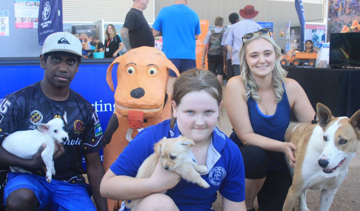 PUPPY PALS: Mount Isa Mines brought Paws Hoofs and Claws to MineX. Mishmael Kelly (14), Christine Horwood (7), Natalie Harrison, Boss the dog. Photo: Esther MacIntyre