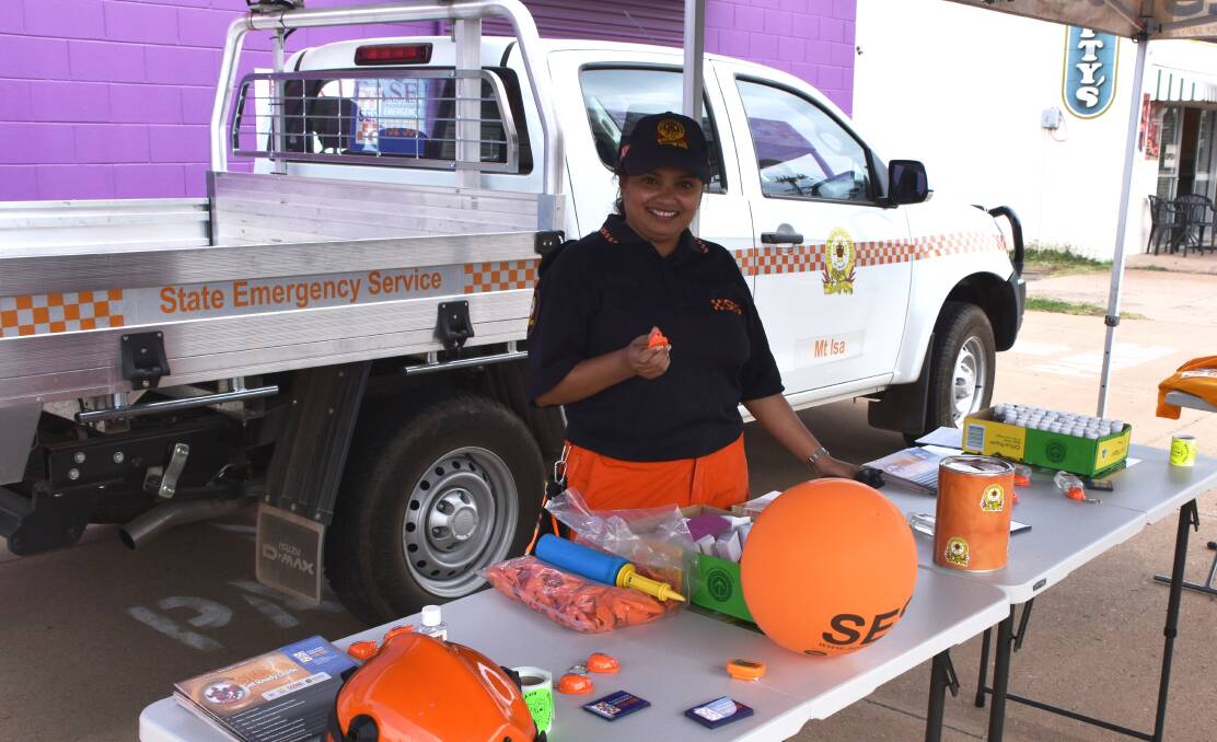 HIGH VIS: SES volunteers had goodies to hand out, including tiny orange helmet key rings which light up when you press their tops! Photo: Esther MacIntyre.