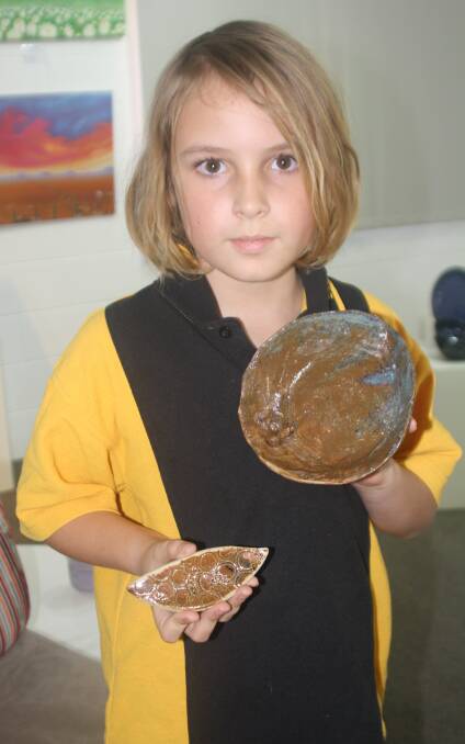 Budding potter Reuben McDonald (9) explained to us how the glazing process works, and how to use iron oxide.