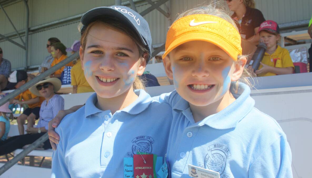 GIRLS IN BLUE: Mount Isa School of the Air students Jemma Curr (10) and Emily Towne (9) enjoying their time at athletics day. Photo: Esther MacIntyre