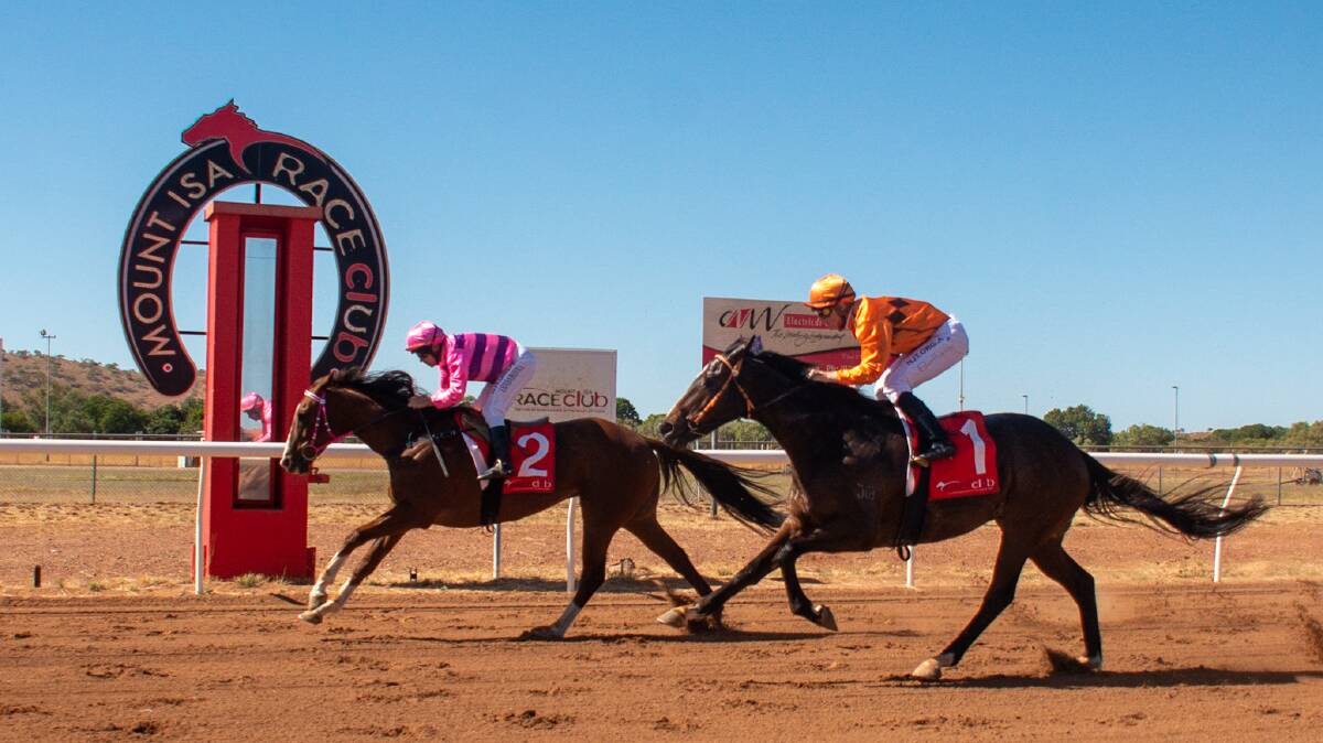Veteran galloper Loud Enough (pink and purple hoops) ridden by Terrence Hill has three wins and two placings from his past five starts including victory at Mt Isa on June 20. Picture: Jason Hoopert Photography.com