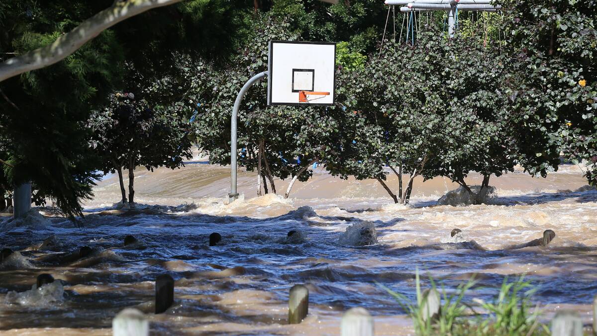 Flooded scenes in Logan, south of Brisbane, as the suburb reached its peak, Tuesday. Photo: AAP Image/Jono Searle