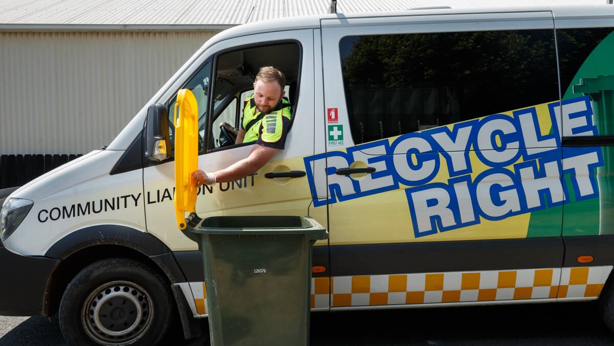 LIFTING THE LID: Chris Lewis is part of a team from Recycle Right which checks the contents of people's recycling bins in the Maitland Local Government Area. PICTURE: Max Mason-Hubers.