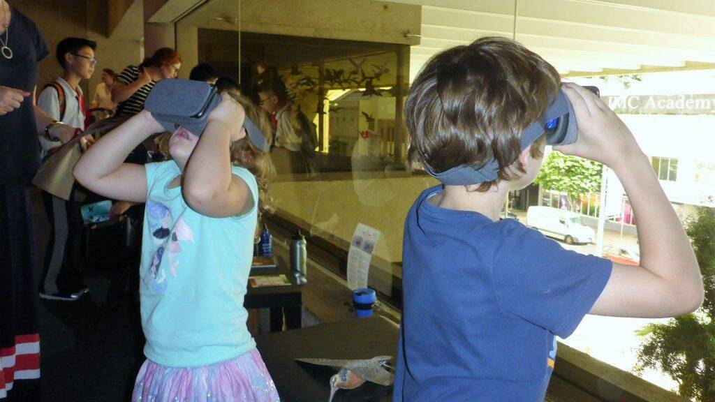 Children participating in the interactive CoralWatch display with Virtual Reality. Photo: Supplied