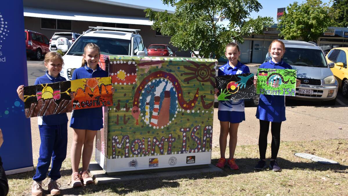 Students from Happy Valley State School displayed their original paintings next to the NBN node Mount Isa Signs copy-painted. Photos: Melissa North