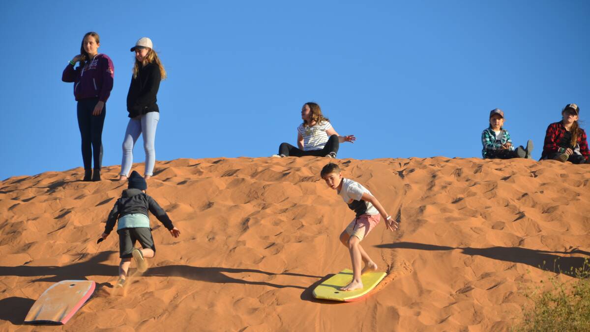 BIG RED BASH: The red sand dune kept the younger ones entertained. 