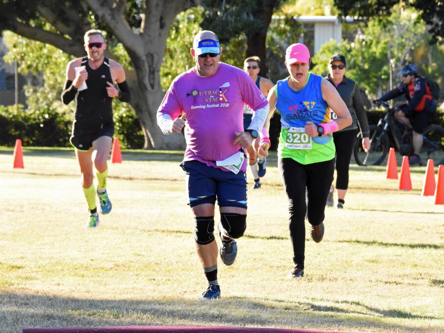 John Doody Jnr (L) in the black singlet prepares to pass other runners from different categories to win the 21km run race on Sunday morning. Photos: Melissa North