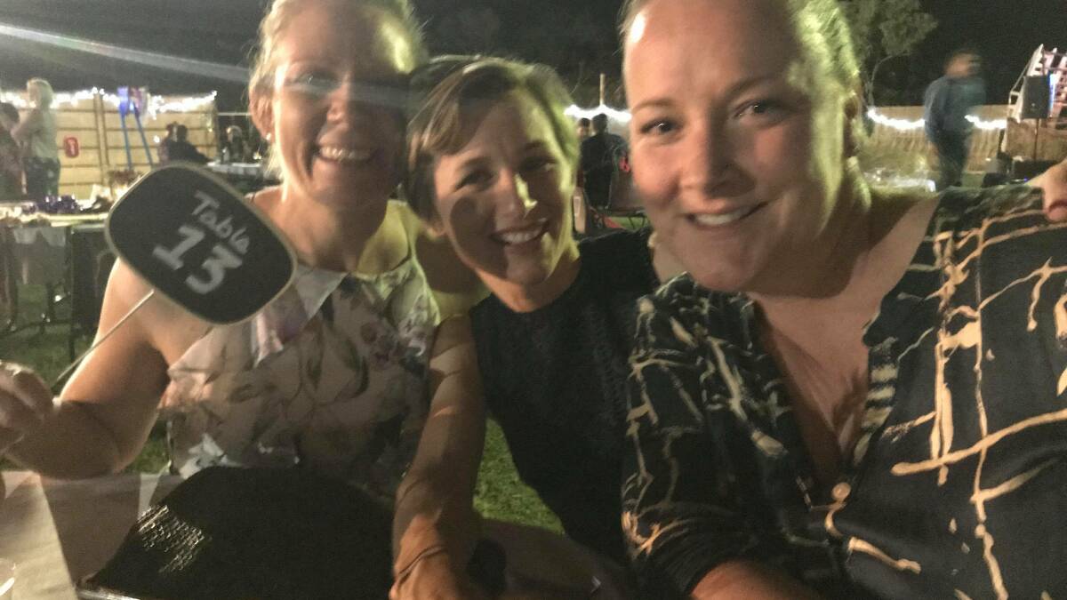 FORMAL DINNER: Danielle Lanson, KelliSlatter and Emma Reilly enjoyed the entertainment from Bulldust at the Dinner in the Round Yard. Photo: Supplied