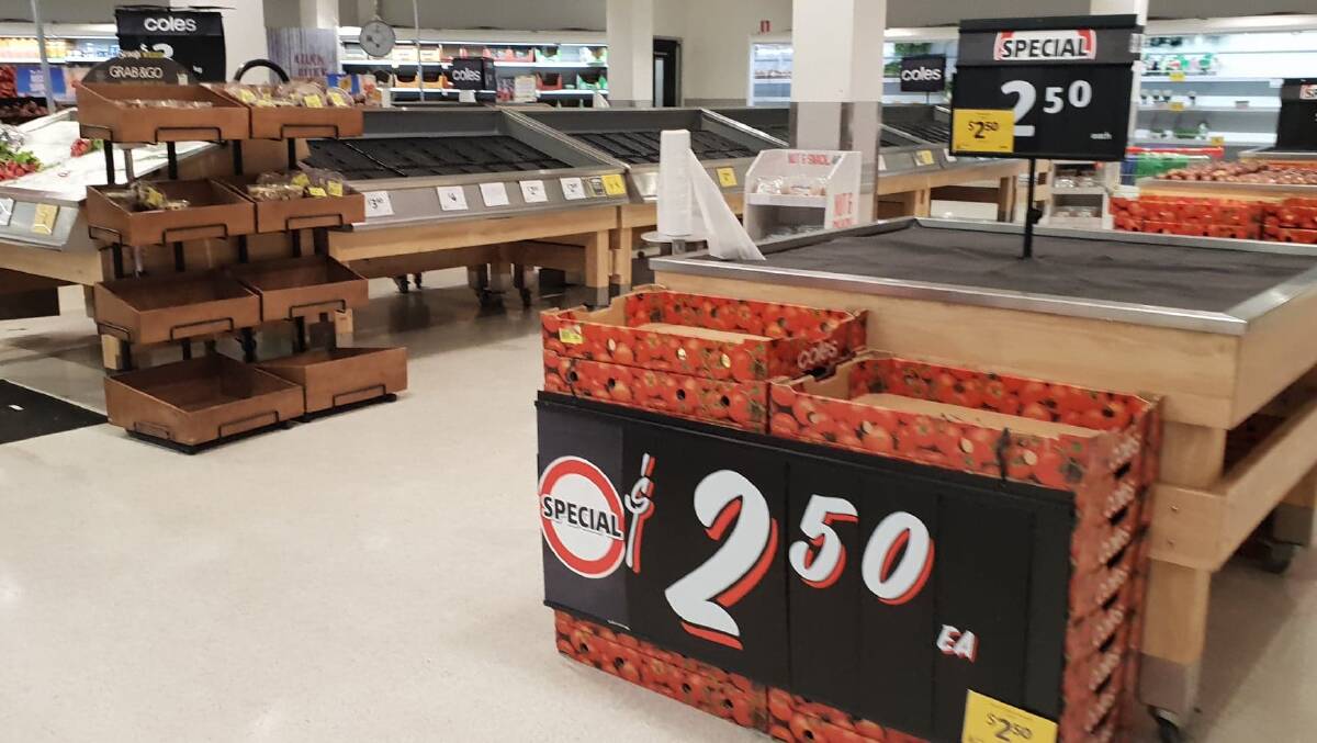 EMPTY SHELVES: Shoppers have emptied the shelves at Coles and the fruit and vegetables.