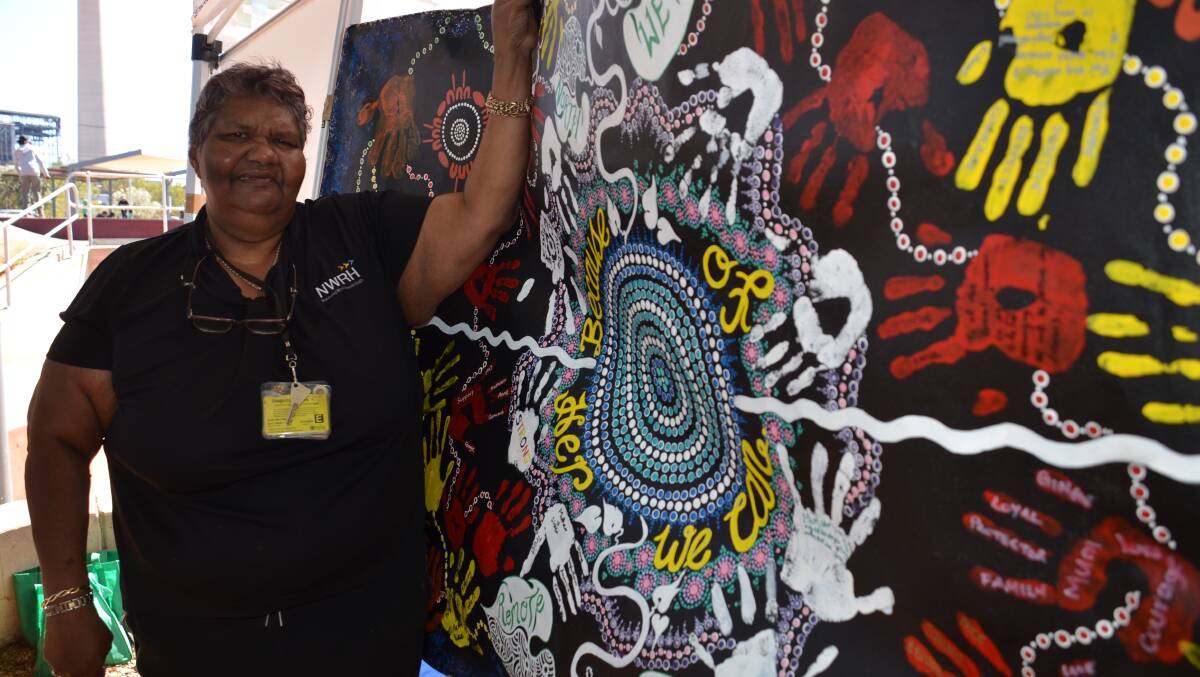 Kerry Major with the painting NWRH office officers did for Naidoc 2018.