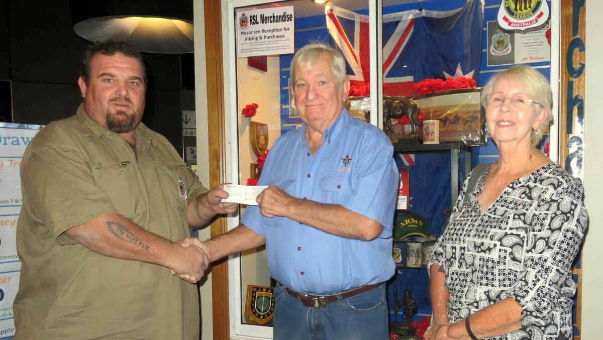 Carl Sorrenson shook hands with Arthur and Beryl Dennis after receiving a cheque.