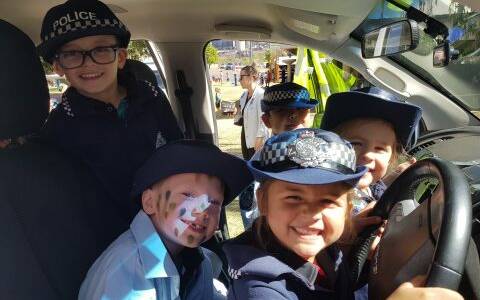 UNDER 8s DAY: Many of the children enjoyed dressing up in the police uniforms and pretending to drive the car. Photos: Supplied