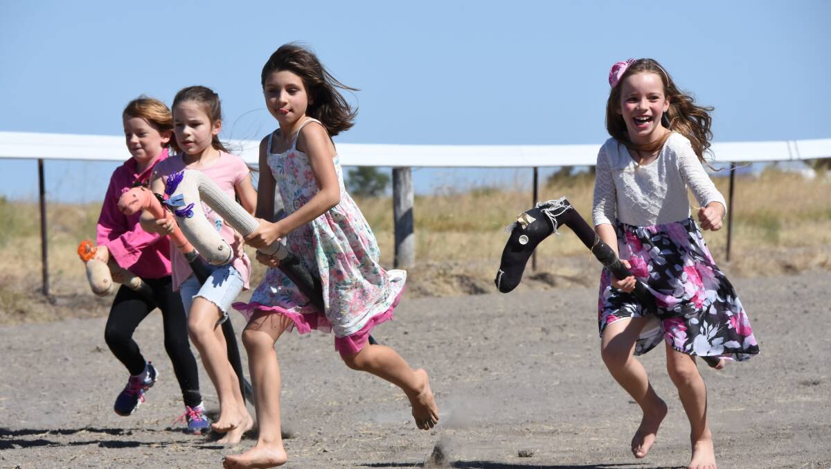 AND THEY'RE RACING: The wooden pony races at the Jockey Club held at the Gregory on Saturday bought huge smiles to the competitors faces. Photo: Melissa North