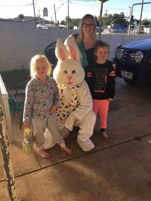 LAST YEAR: The Easter Bunny and a Mount Isa Rotary Rodeo Queen Quest entrant arrived early to surprise these children last year. Photo: Supplied